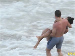 pinkish bathing suit first-timer stripped to the waist spycam Beach women