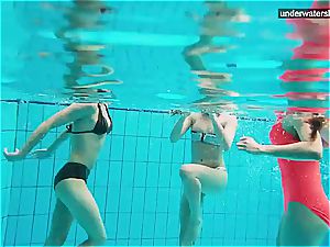 three bare nymphs have fun underwater